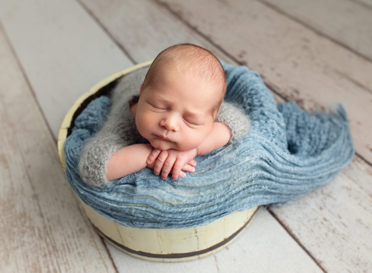 sleeping newborn in bowl