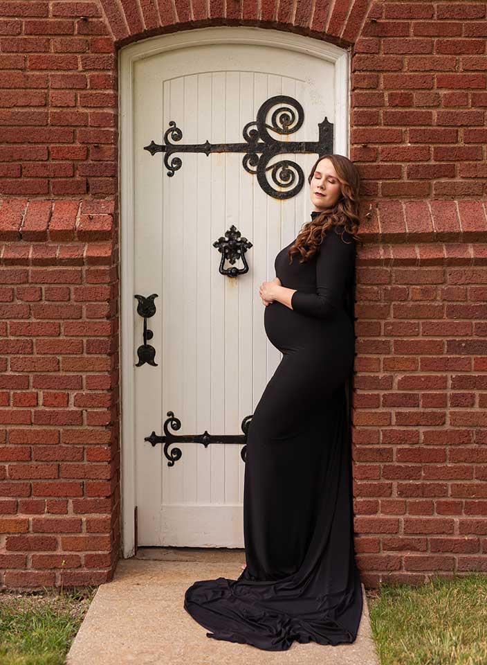pregnant woman posing in gown for maternity photos