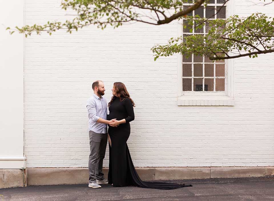 expectant couple posing for maternity photos