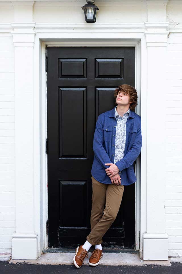 high school boy posing for senior pictures in Hudson Ohio