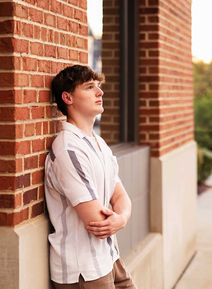 high school boy posing for senior pictures in Hudson Ohio