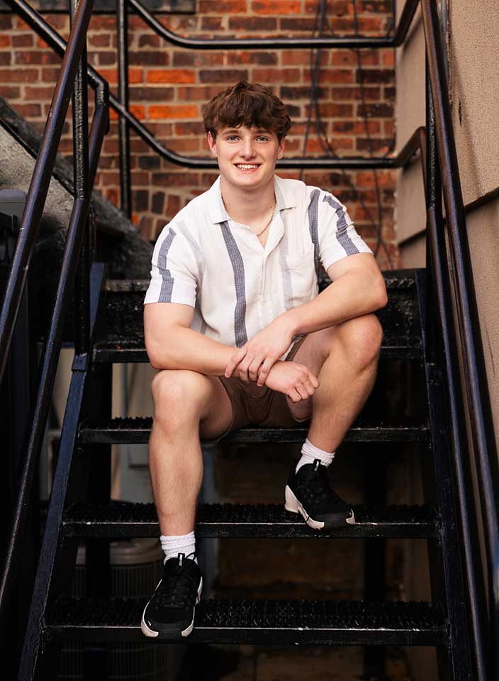 high school boy posing for senior pictures in Hudson Ohio