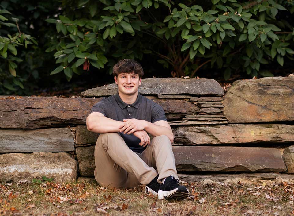 high school boy posing for senior pictures in Hudson Ohio