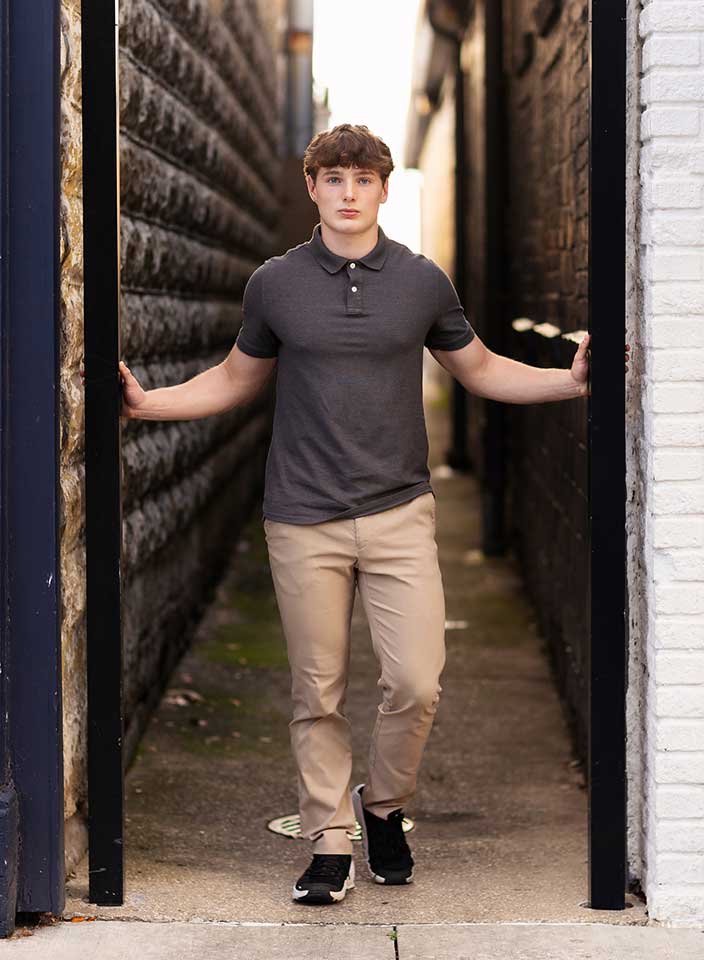high school boy posing for senior pictures