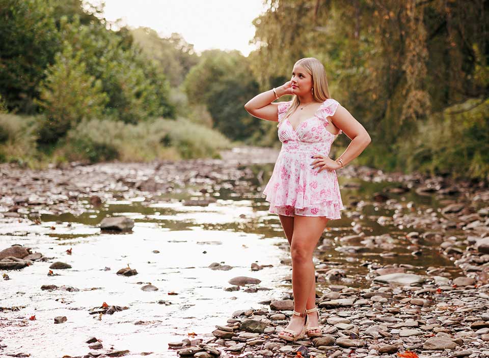 senior girl posing for photos on riverbank