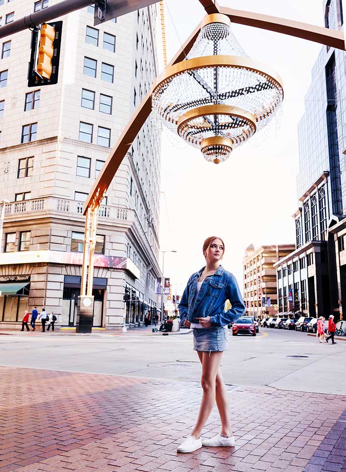 senior girl posing under chandelier at Playhouse Square