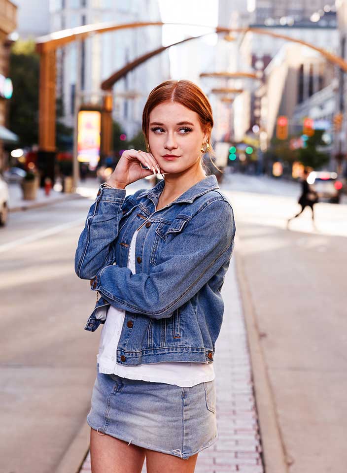 Teenage girl posing near Playhouse Square chandelier for senior pictures