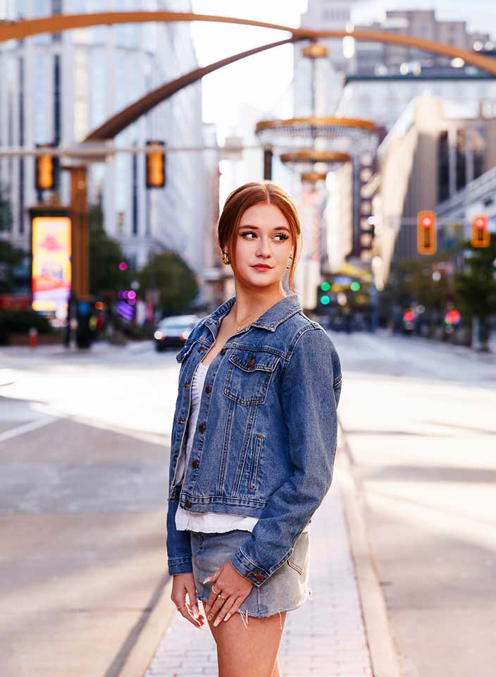 Teenage girl posing near Playhouse Square chandelier for senior pictures