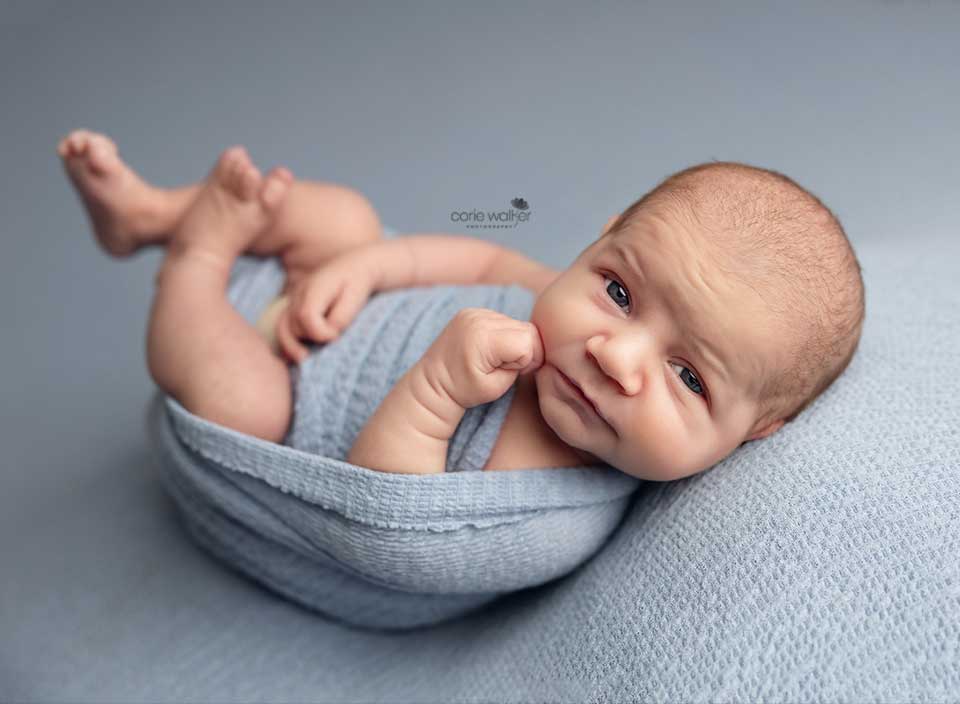 awake newborn baby boy staring at camera