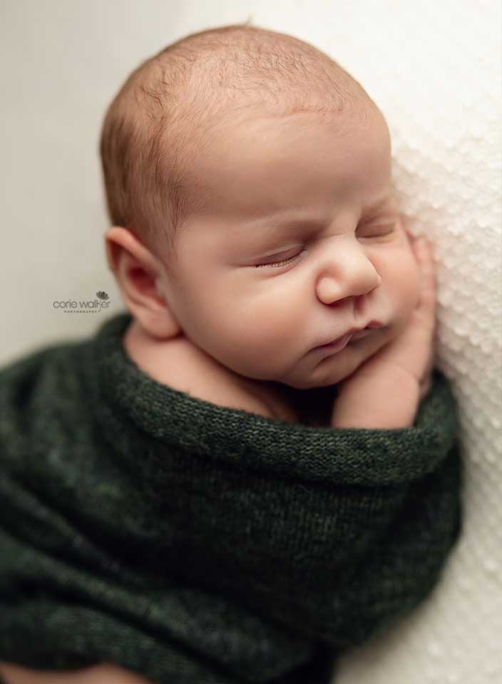 sleeping baby boy in green