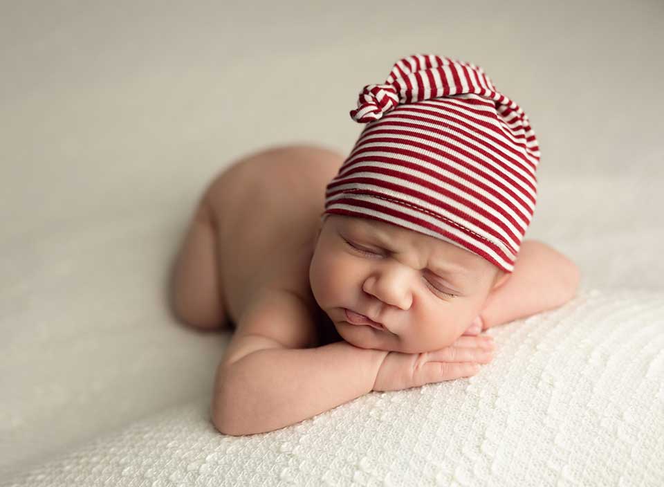 newborn baby boy in red striped hat